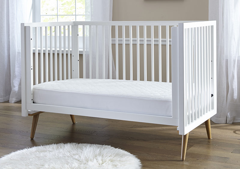 Crib mattress with the Sealy Stain Repel & Release Fitted Crib Mattress Pad