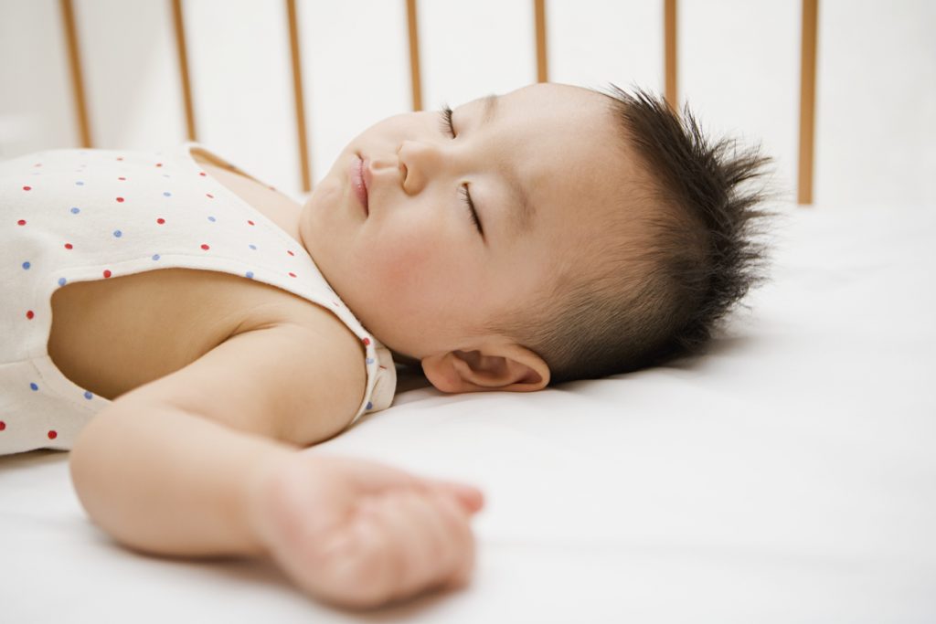 baby sleeping on best crib mattress